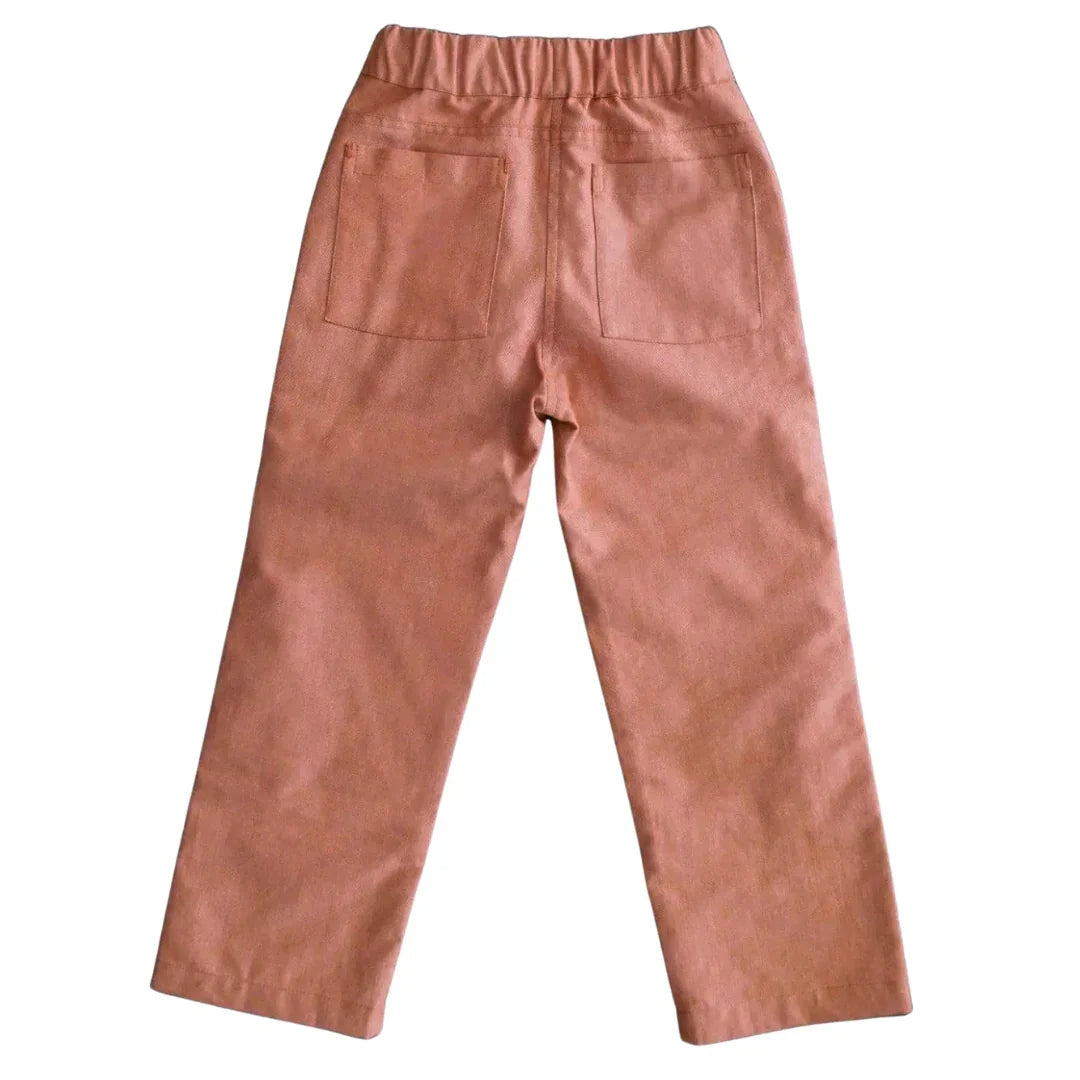 Rear view of pink chambray kids pants with elastic waistband and back pockets by Jackalo