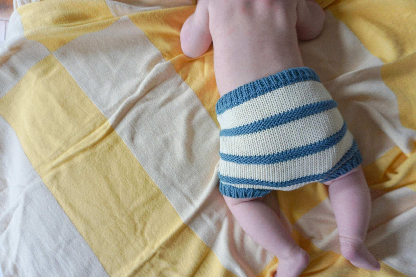 Organic cotton baby bloomers in blue and cream stripes by Jackalo on yellow plaid blanket