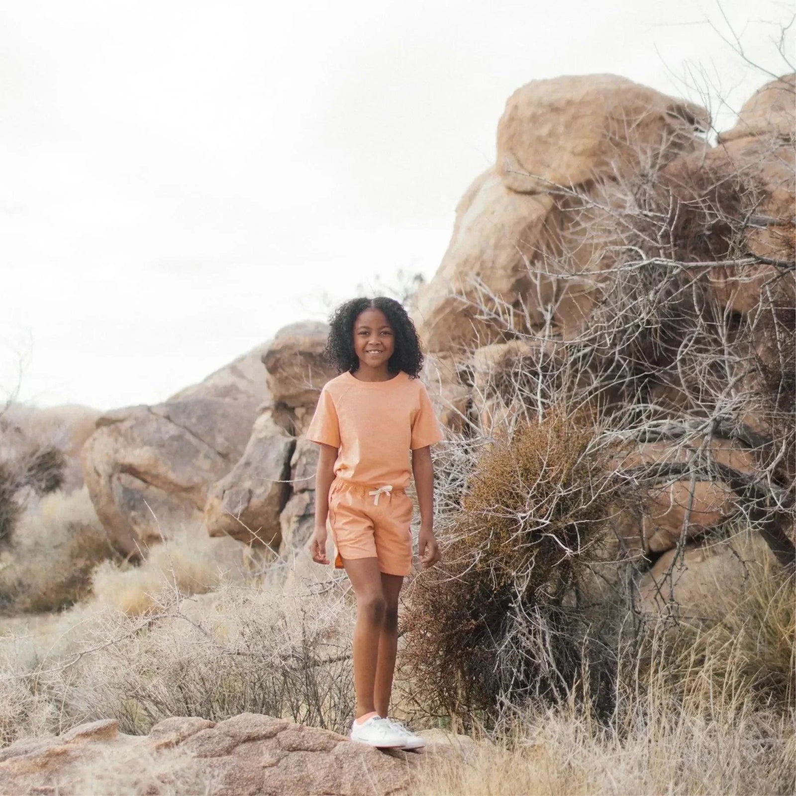 Peach-colored Jackalo kids t-shirt, sustainable fashion, featured in Glamour magazine.