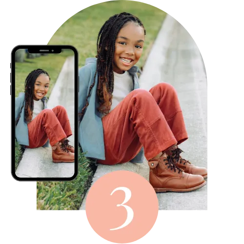 A girl wearing jacket and boots sitting on the ground