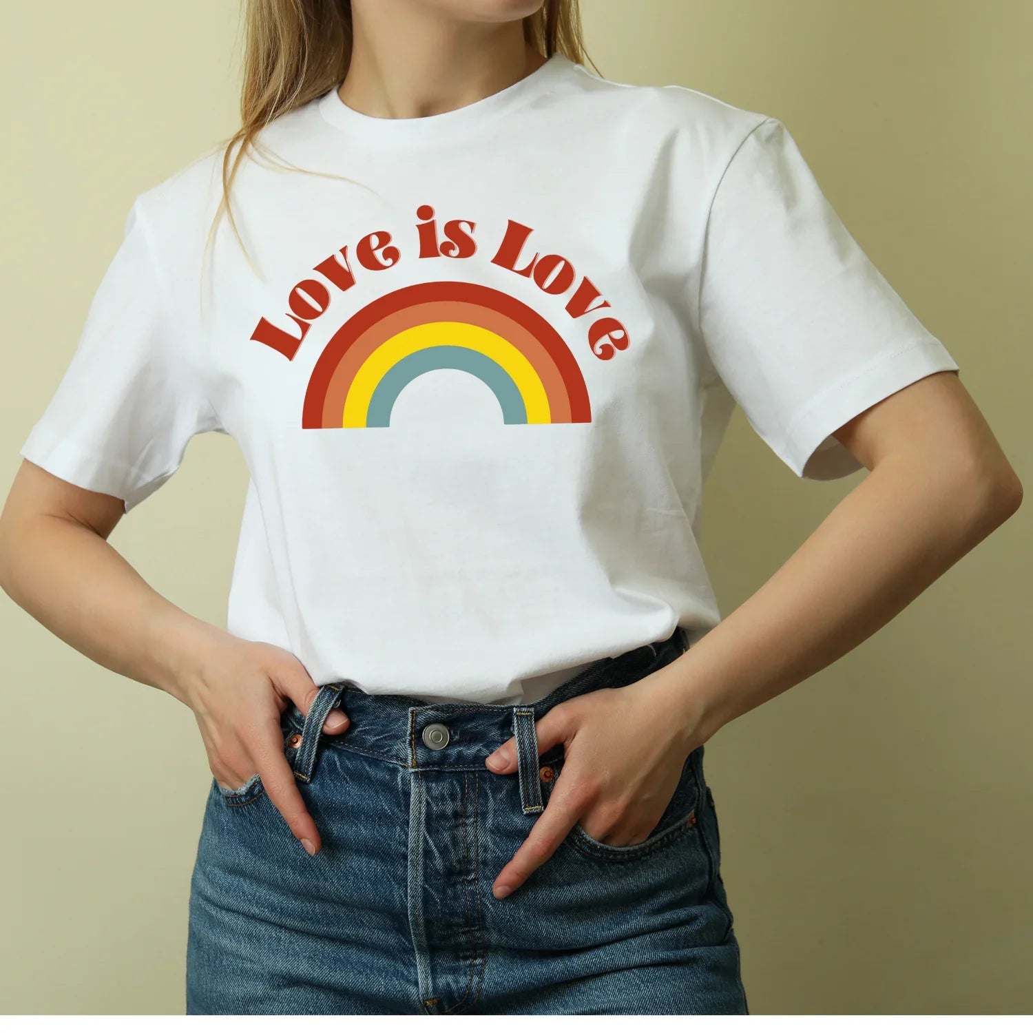 Woman wearing Jackalo white t-shirt with red heart and 'you are loved' text, sustainable kids clothing