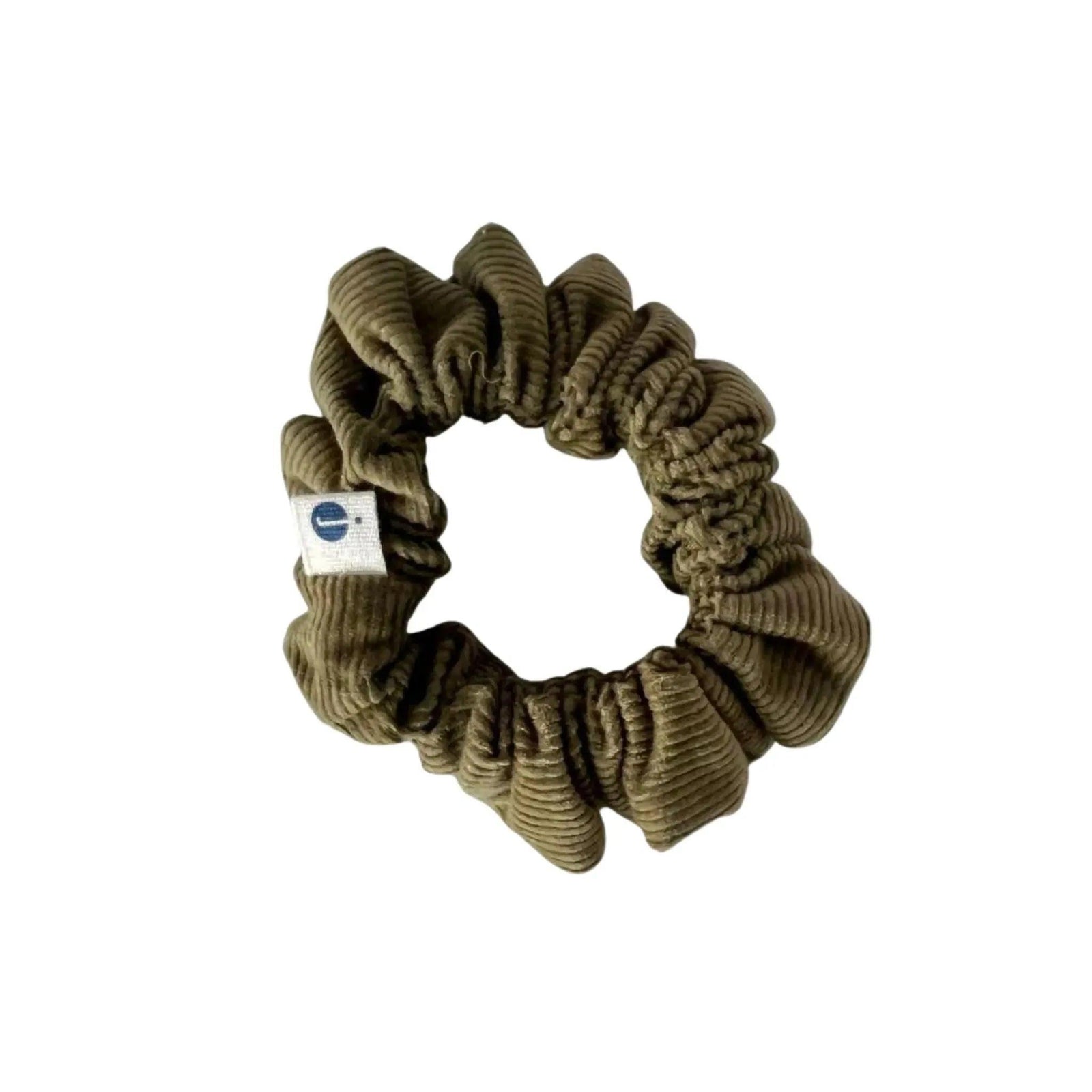 Green corduroy scrunchie hair tie with Jackalo label on white background