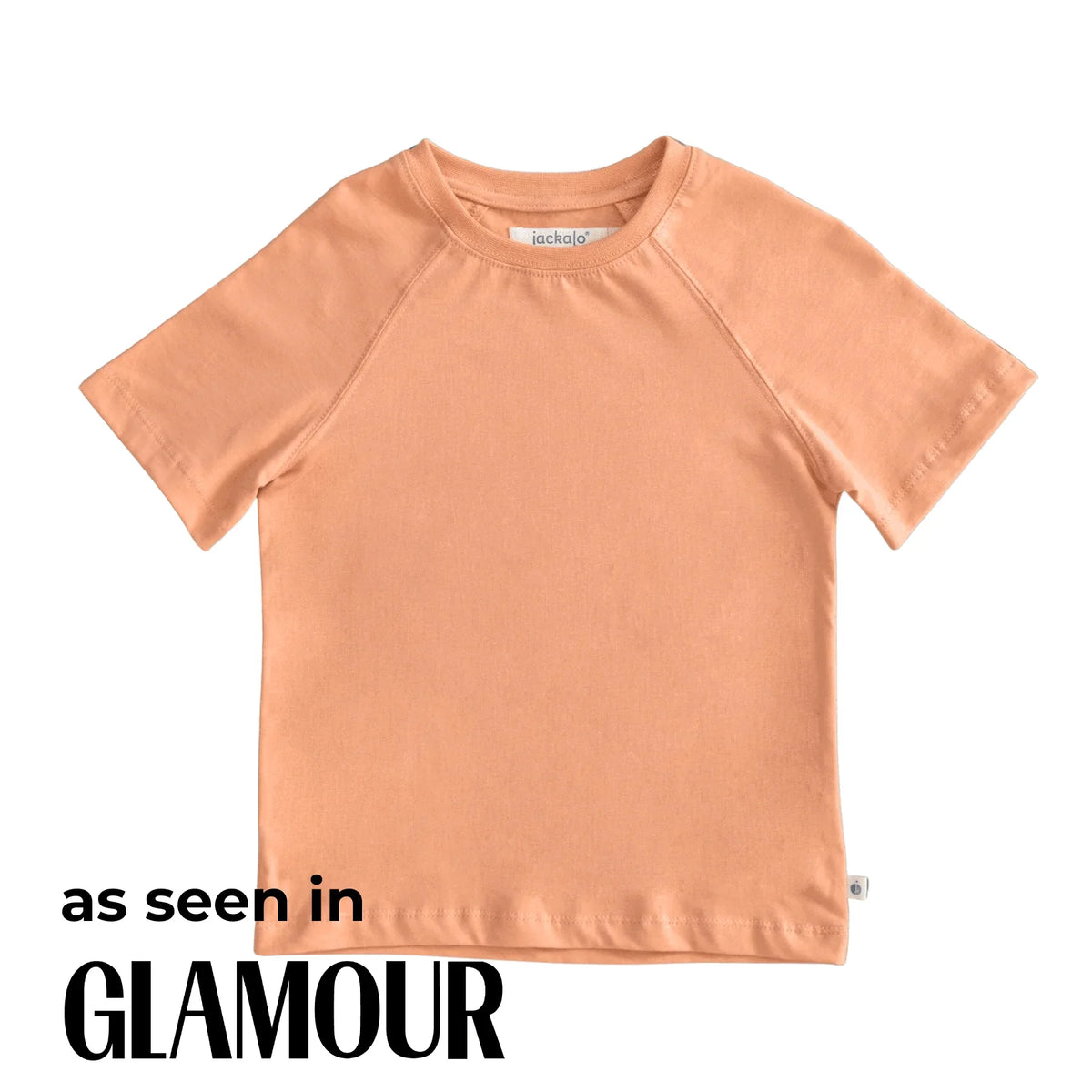 Peach-colored Jackalo kids t-shirt, sustainable fashion, featured in Glamour magazine.