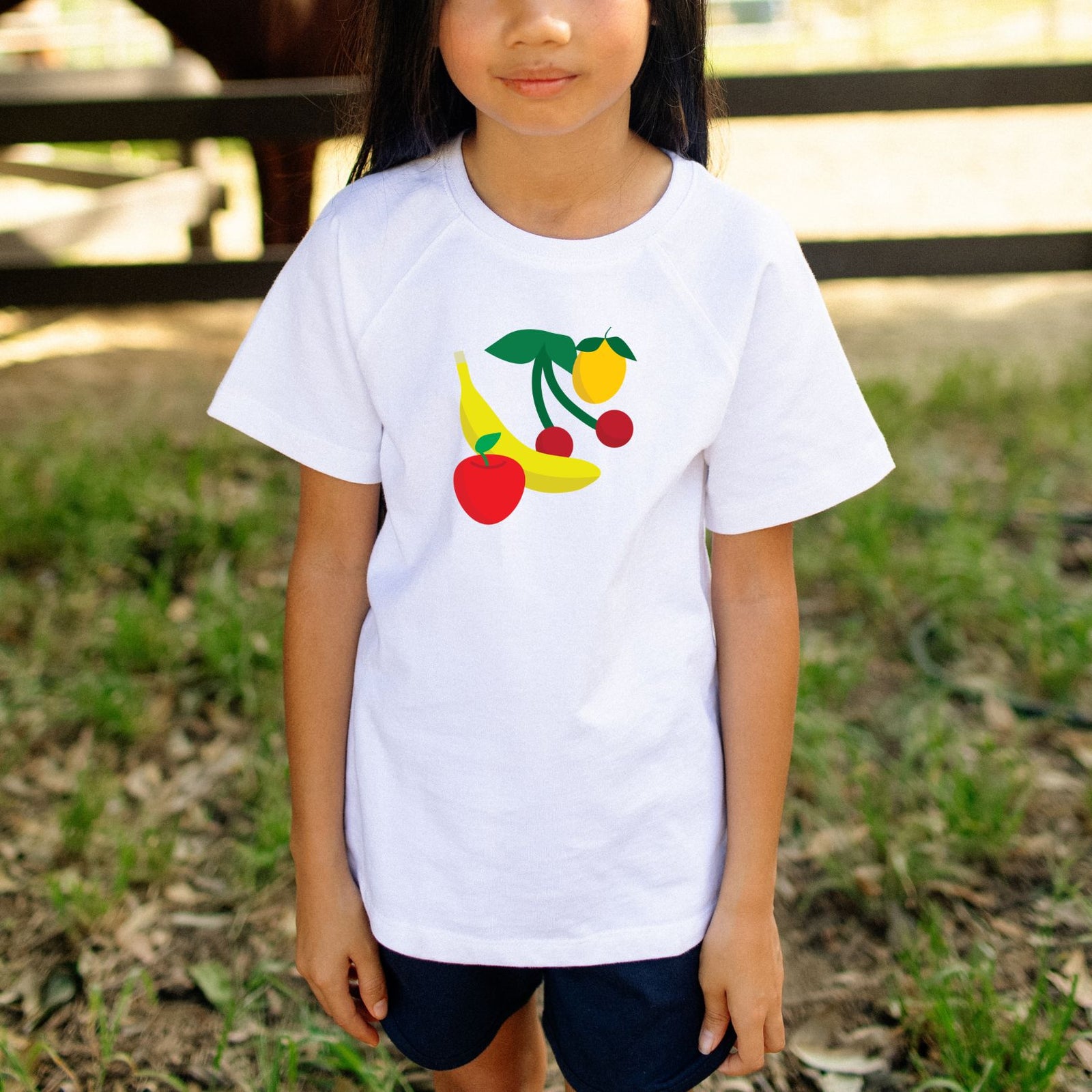 White t-shirt with colorful fruit design on a white background