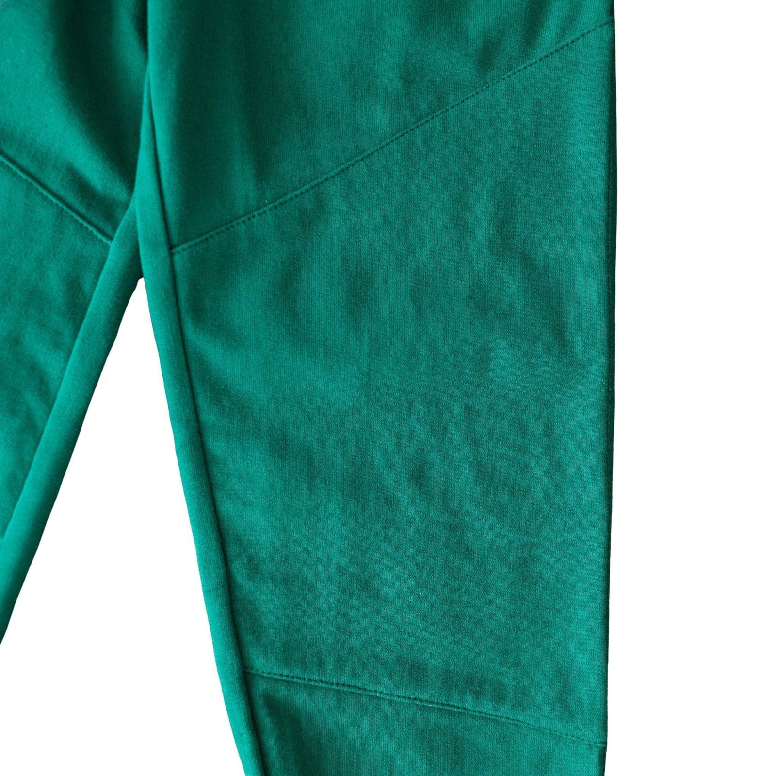 Detail of green kids sweatpants fabric and stitching from Jackalo, sustainable activewear.