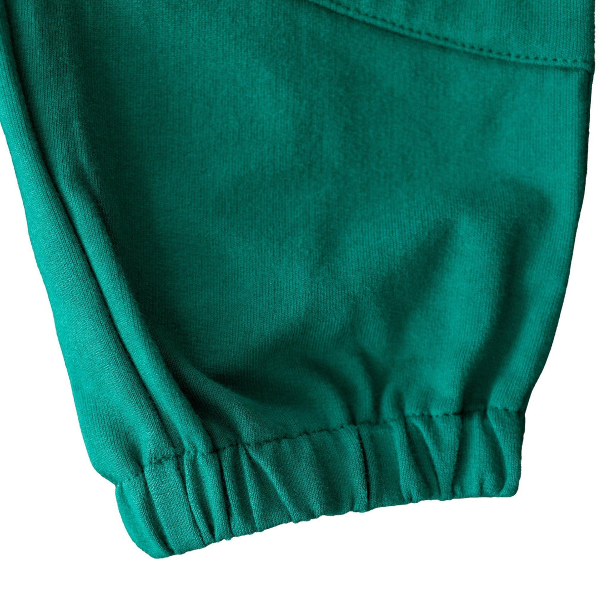 Detail of green kids sweatpant cuff, sustainable Jackalo activewear fabric