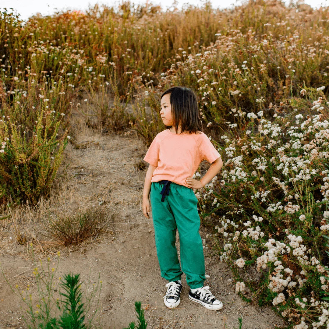 Hunter green kids sweatpants with elastic waist and navy drawstring by Jackalo