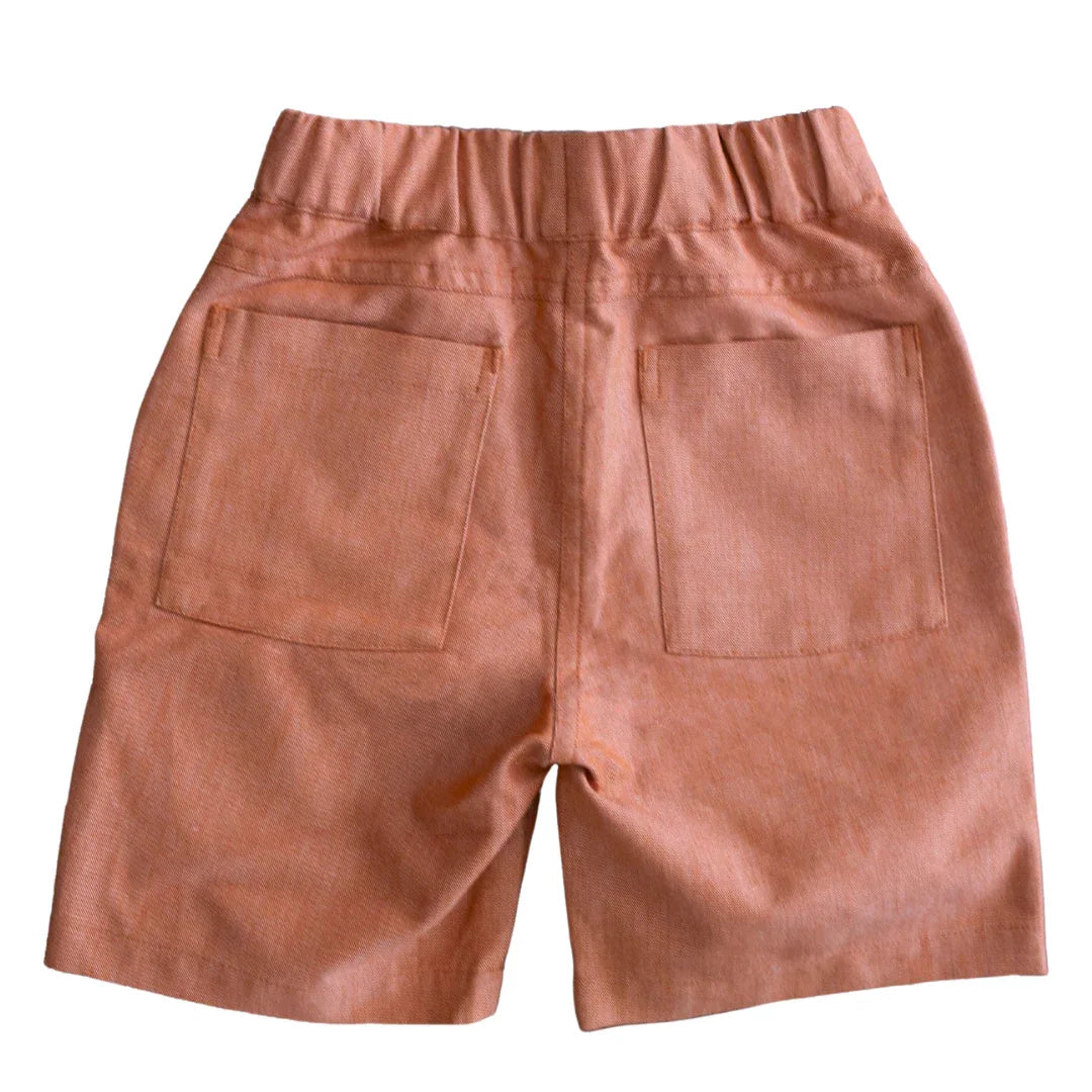 Rear view of Jackalo kids' chambray shorts in orange with elastic waistband and back pockets