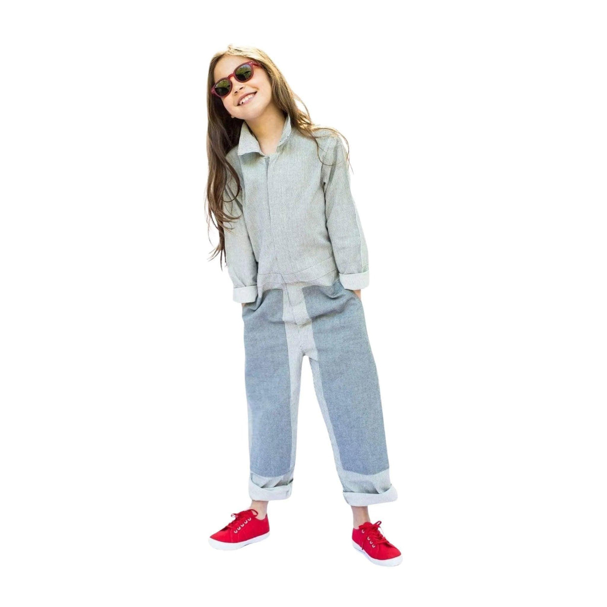 Smiling girl in eco-friendly gray coverall, red sneakers, and sunglasses by Jackalo