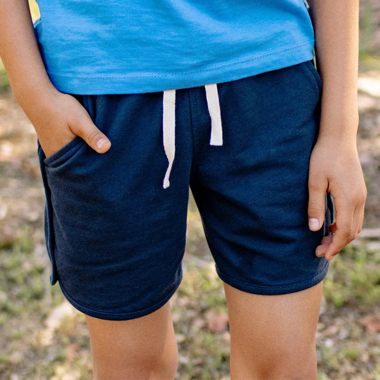Navy kids' shorts with elastic waistband and beige drawstring by Jackalo, sustainable clothing.