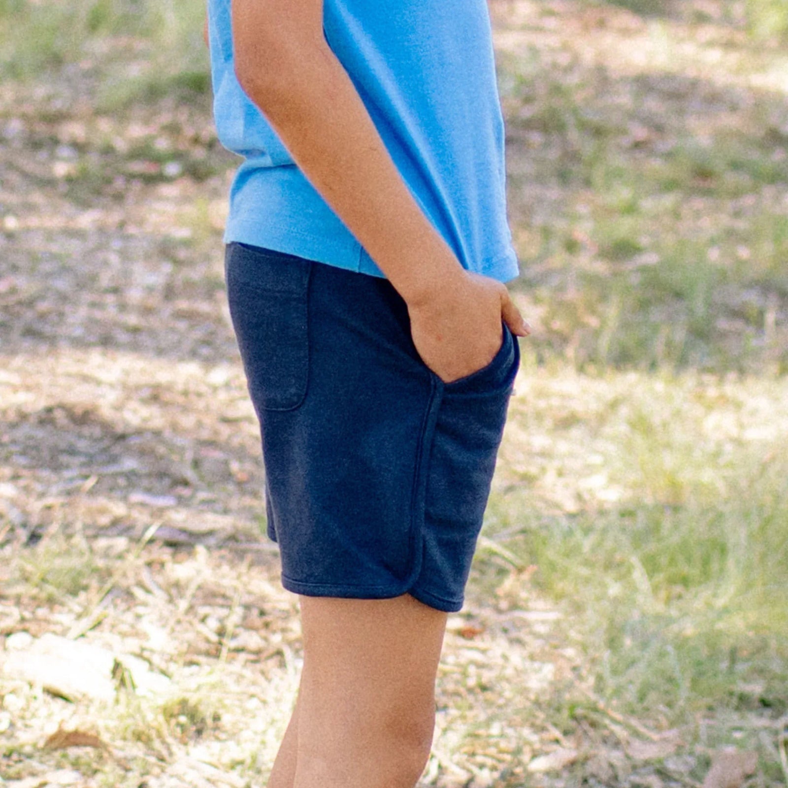 Child wearing Jackalo sustainable navy Ollie shorts outdoors