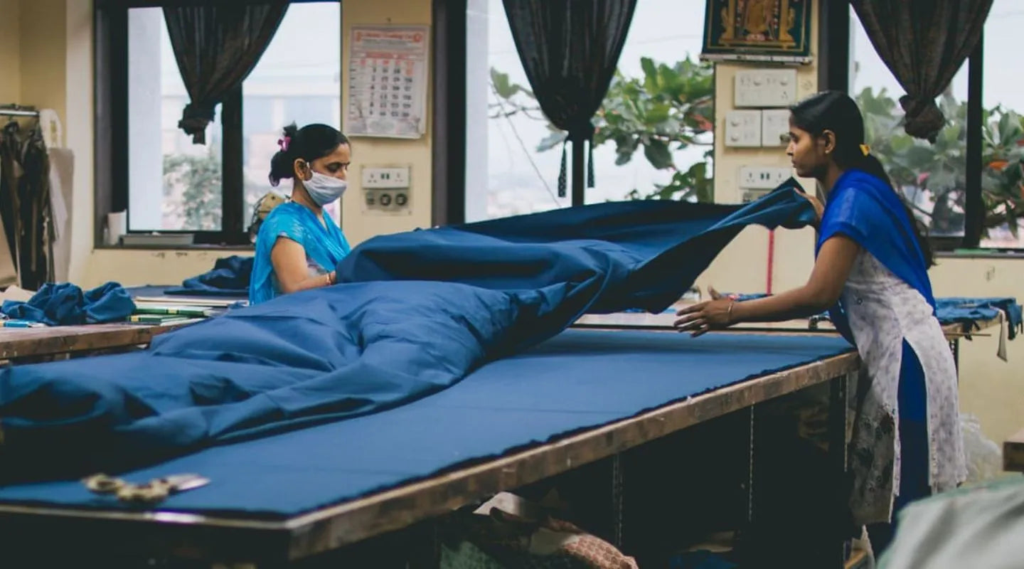 Women working together on bed production in a factory