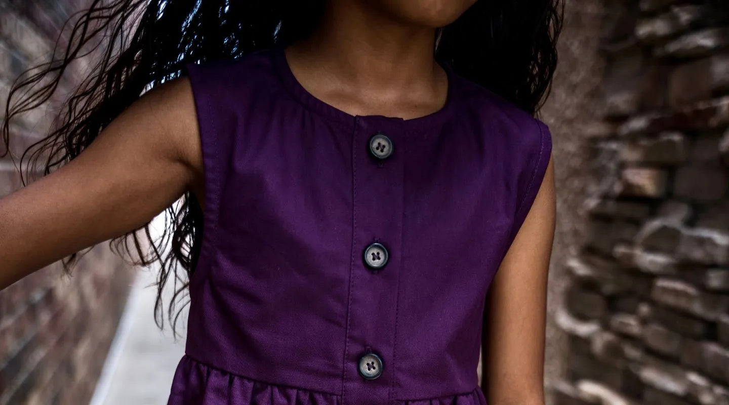 Cropped photo of a young girl in a purple dress