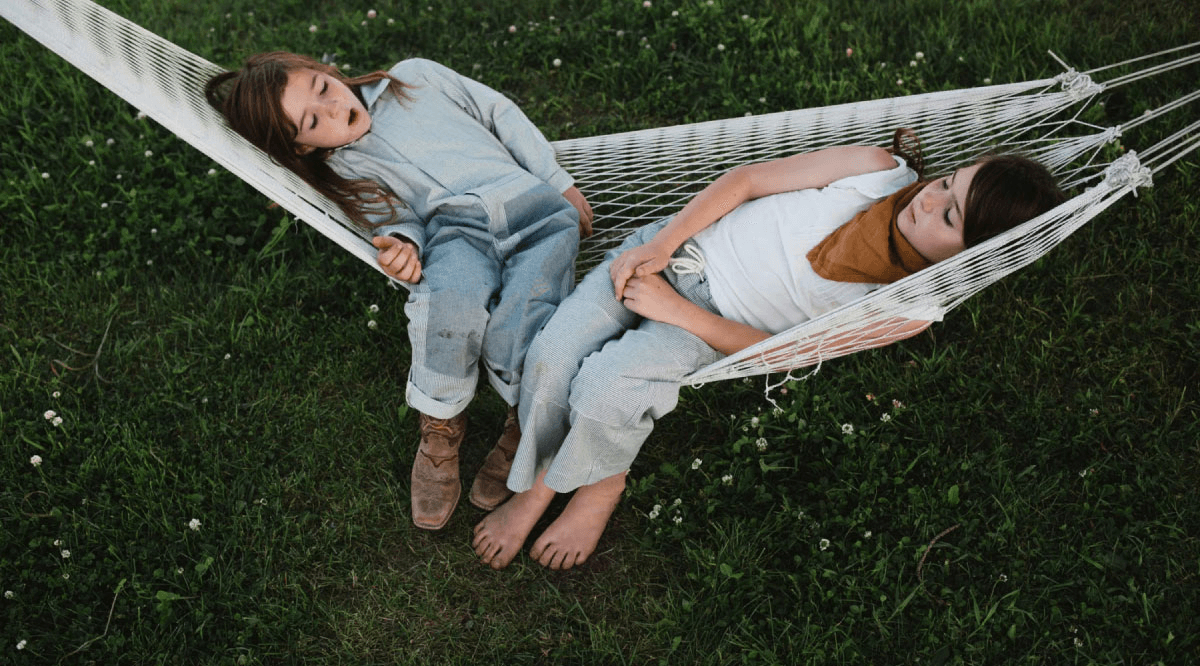 Two girls enjoying a relaxing moment in a hammock